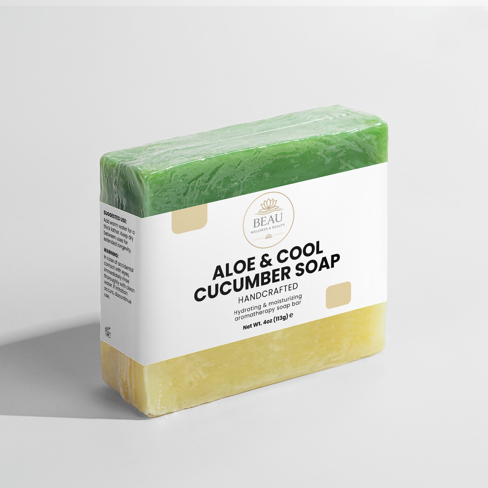 Aloe & Cool Cucumber soap handcrafted bar with green top and white label with Beau Wellness and Beauty logo on a light gray background