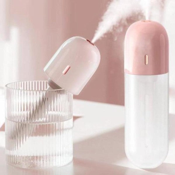 Pink and white travel humidifier with a matching case on a light pink background