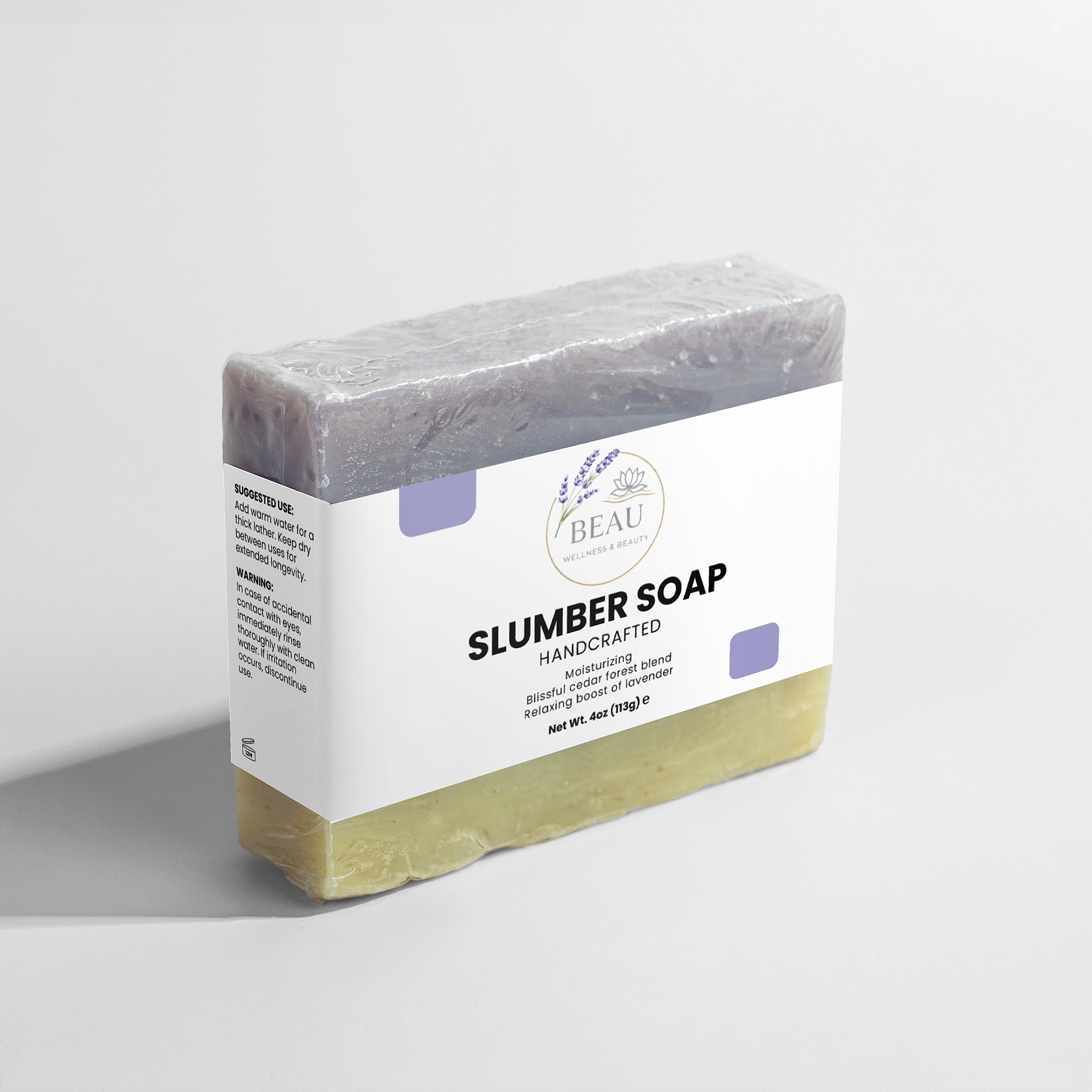 Handcrafted Bar of slumber soap with cedar and lavender with a white Beau Wellness & Beauty label on a light gray background