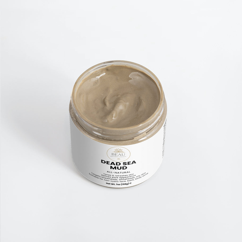 Jar of Dead Sea mud with a white label on a light gray background