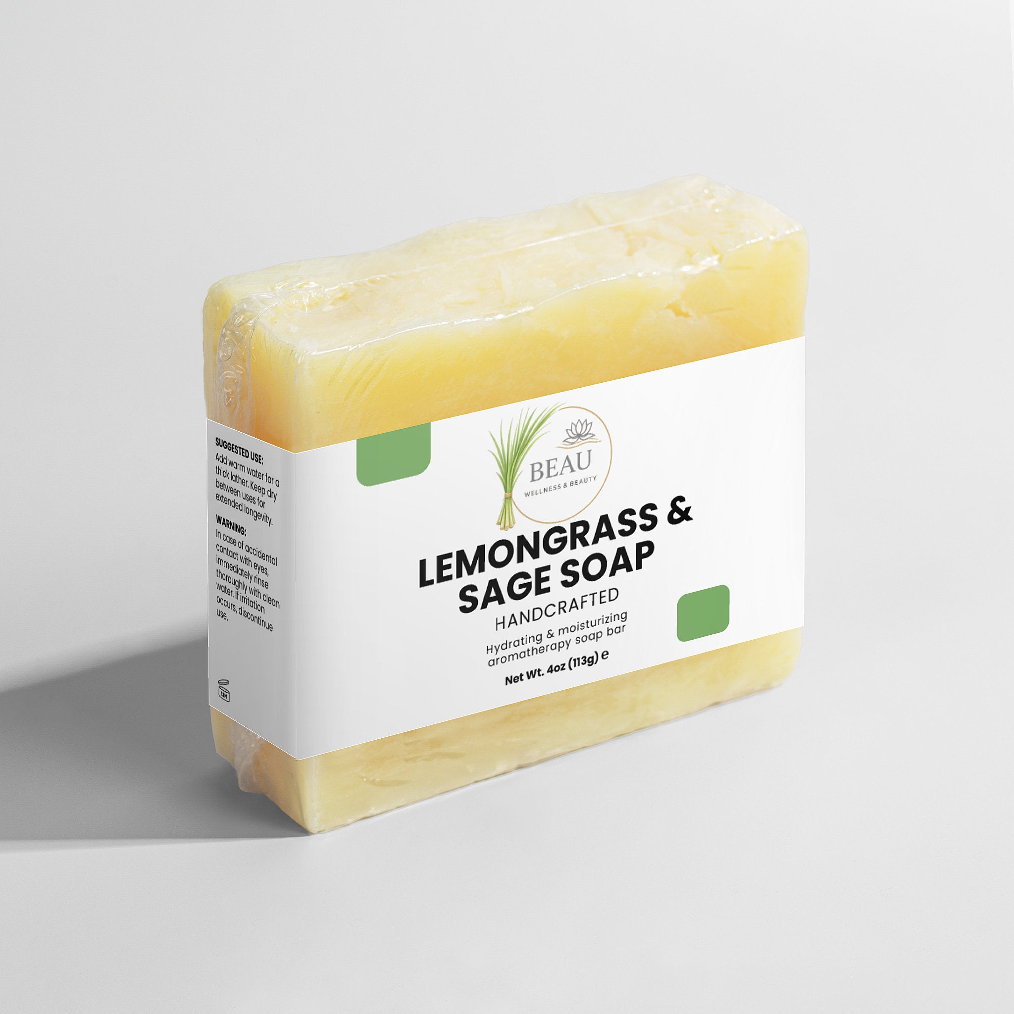 handcrafted Bar of lemongrass and sage soap with a white Beau Wellness & Beauty label on a light gray background