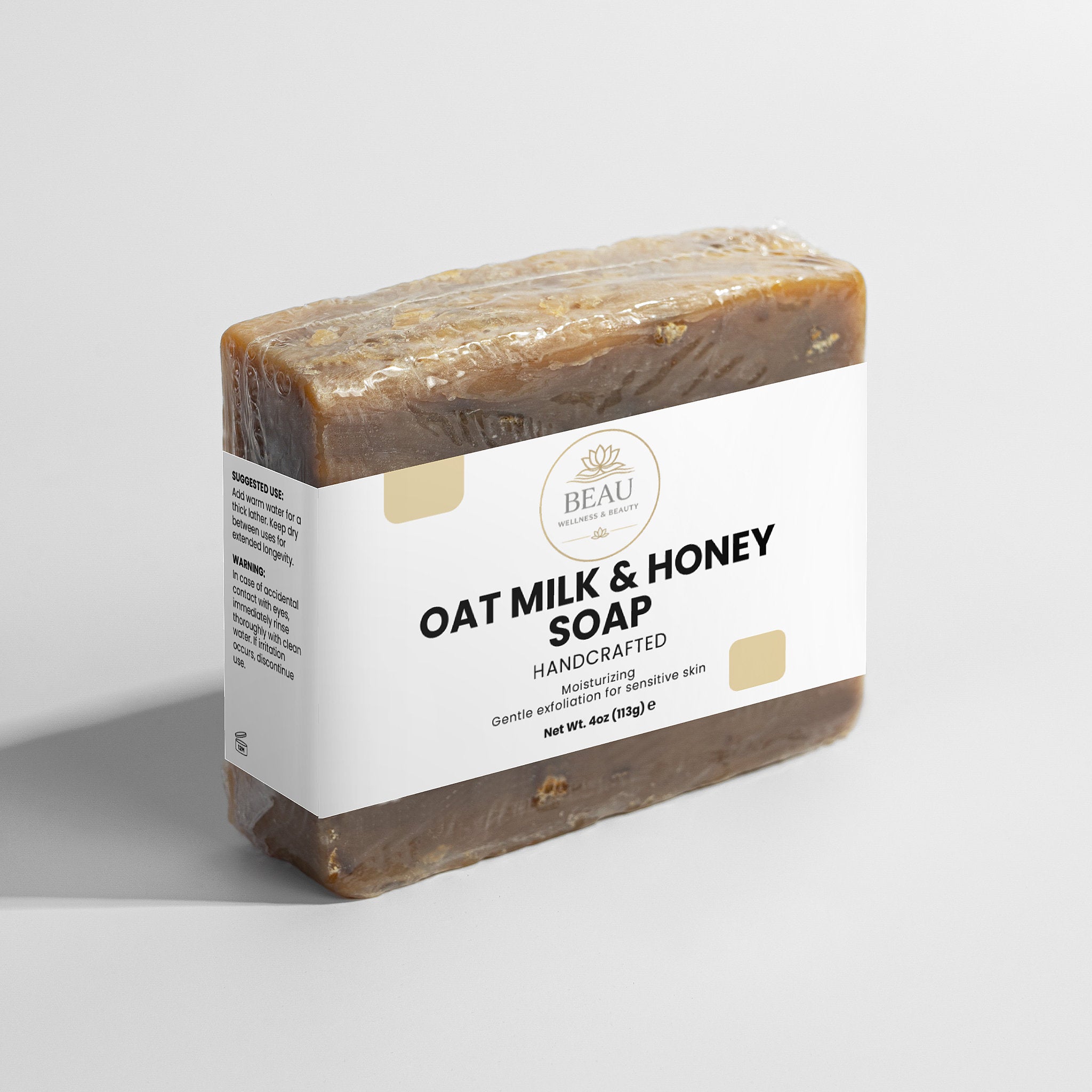 Oat milk and honey soap bar with a white label on a light gray background