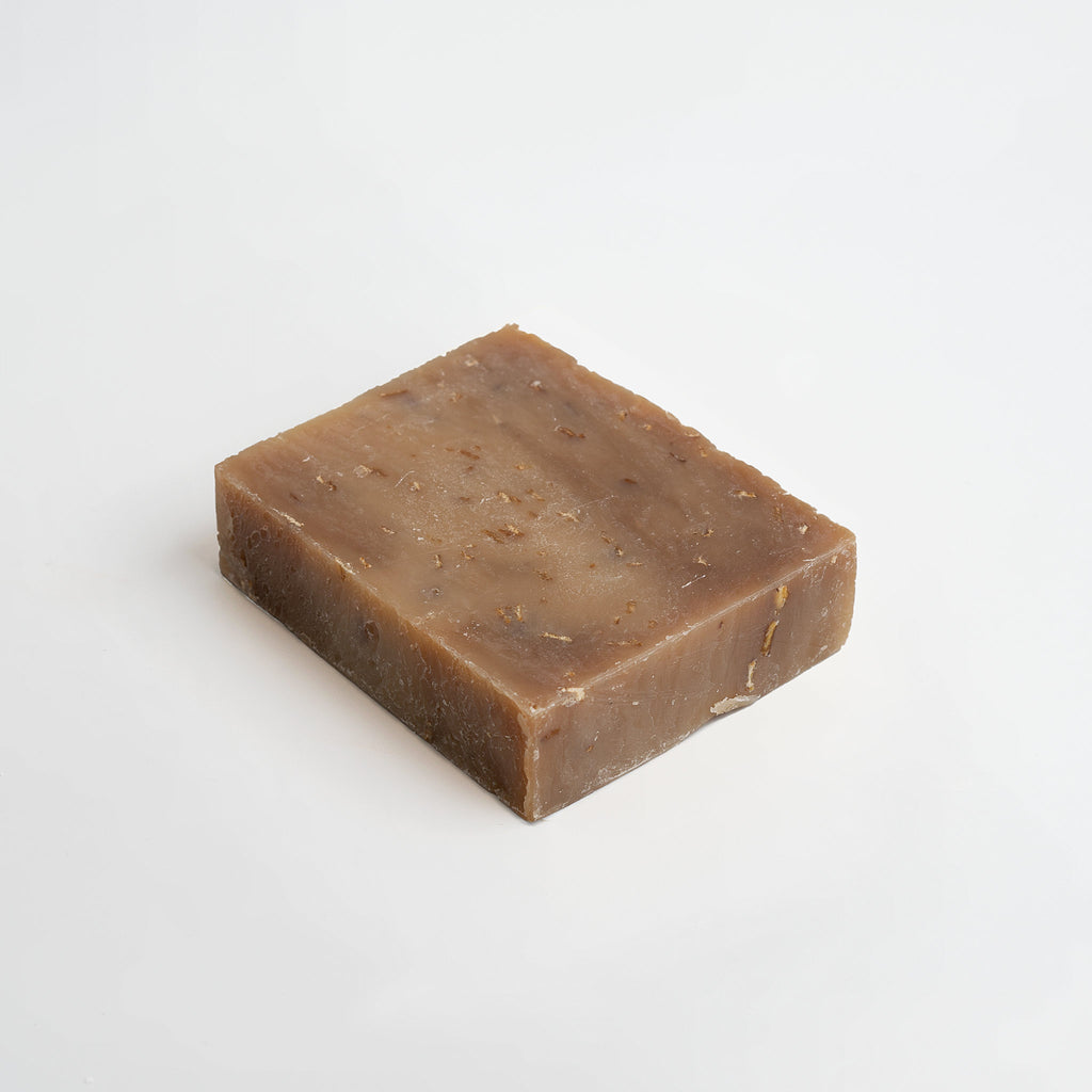 Bar of brown Beau Oat Milk & Honey handcrafted  soap on a white background