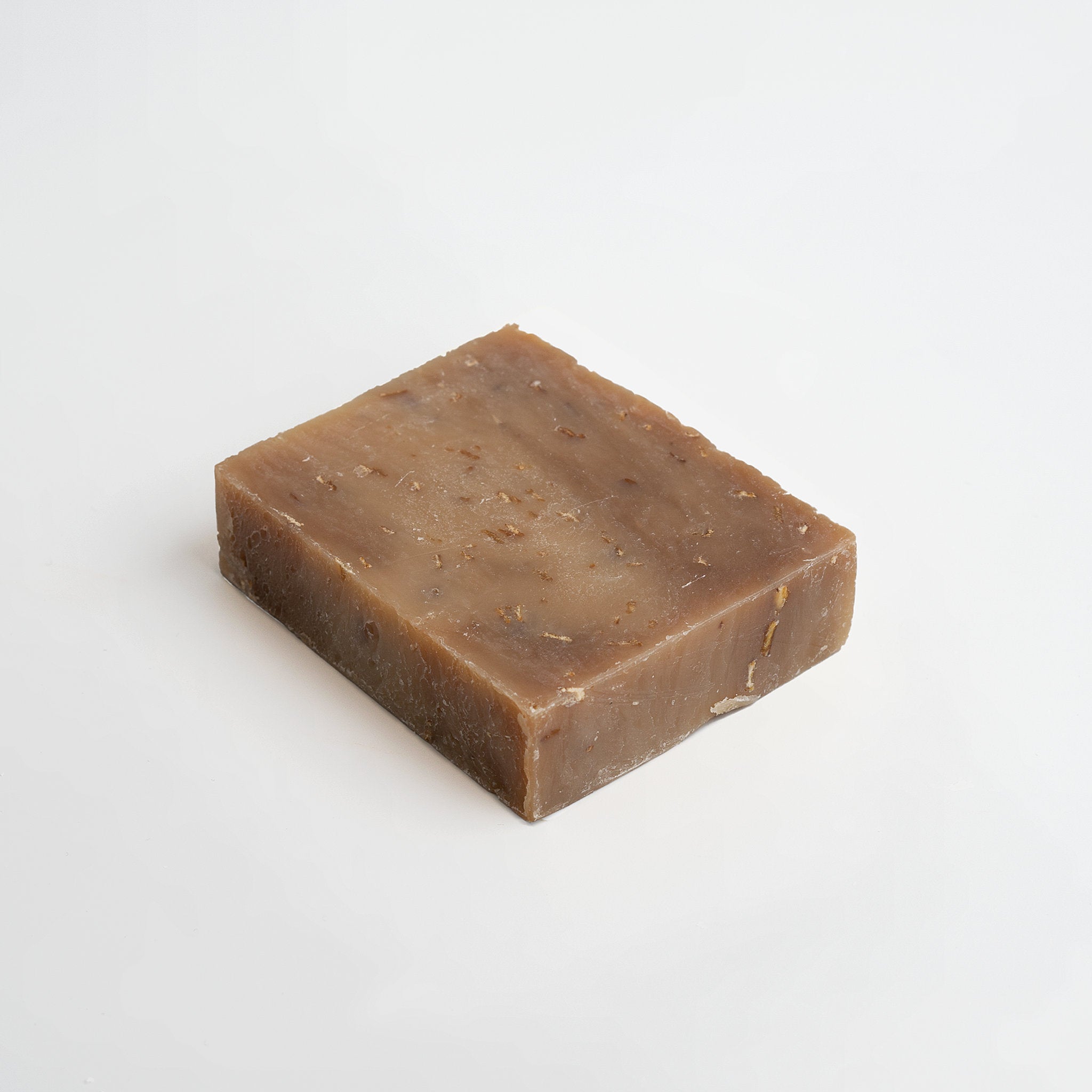 Bar of brown Beau Oat Milk & Honey handcrafted  soap on a white background