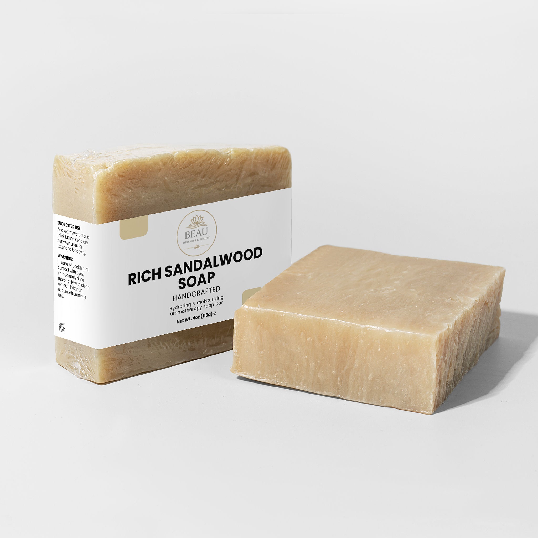 Two handcrafted bars of Rich Sandalwood soap with a label on a light gray background