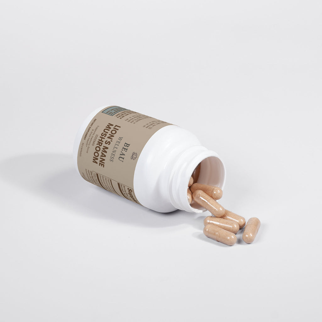 Beau Wellness Organic Lions Mane Mushroom Vegan Capsules for Focus and Memory⁠ with capsules falling out on white background.