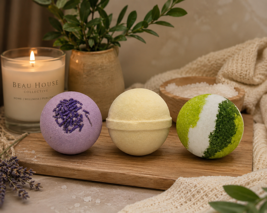 
Three handcrafted round bath bombs lined up on a white background: a purple lavender bomb with dried purple sprinkles, a smooth pastel yellow lemongrass bomb, and a vibrant green and white eucalyptus bomb.
