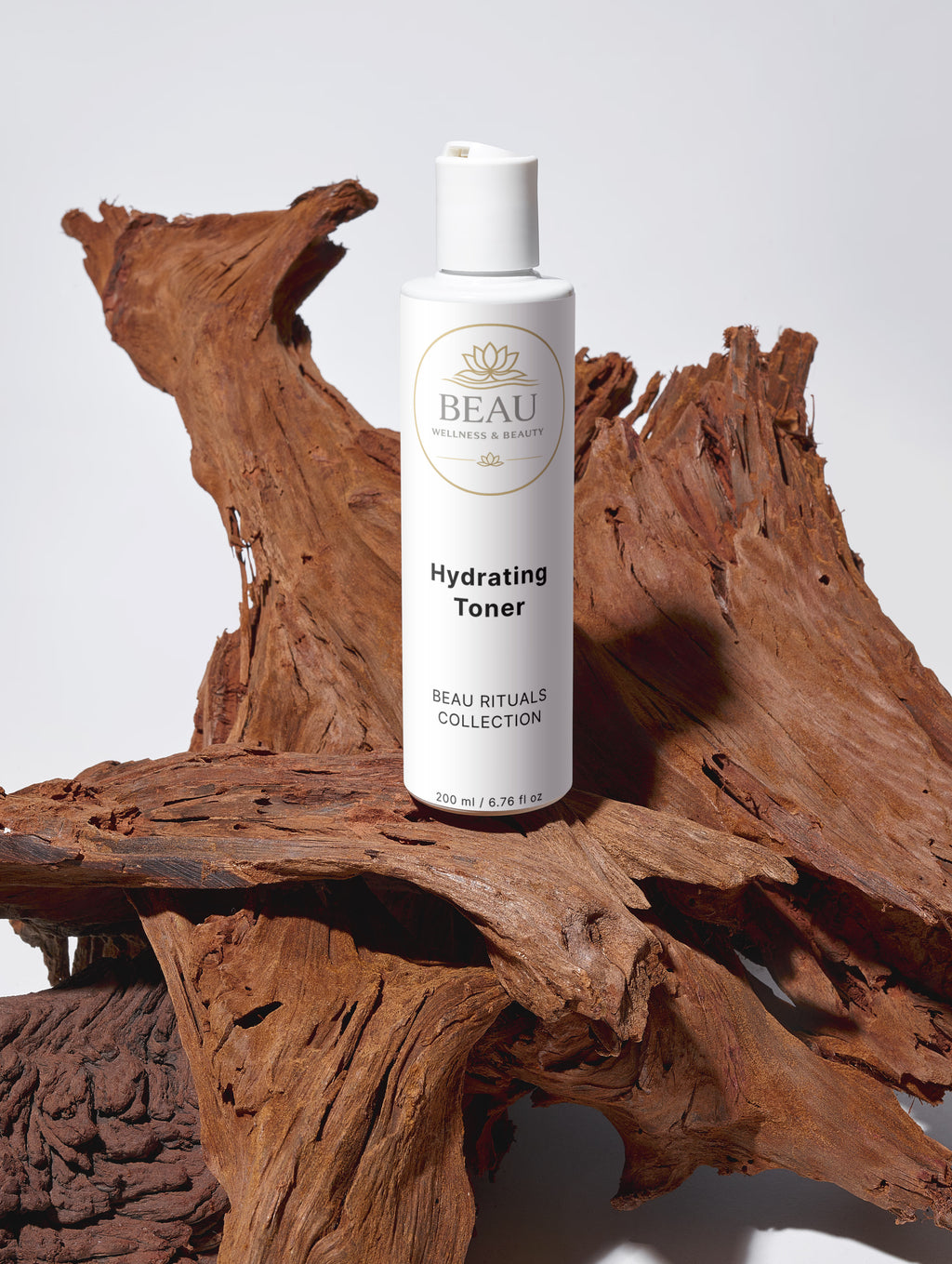 Skincare bottle labeled Beau Wellness & Beauty on a wooden surface with a white background
