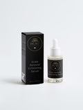 Beau Skincare Scalp Renewal Exfoliating Serum shown with its black retail box and clear dropper bottle on a light gray studio background.