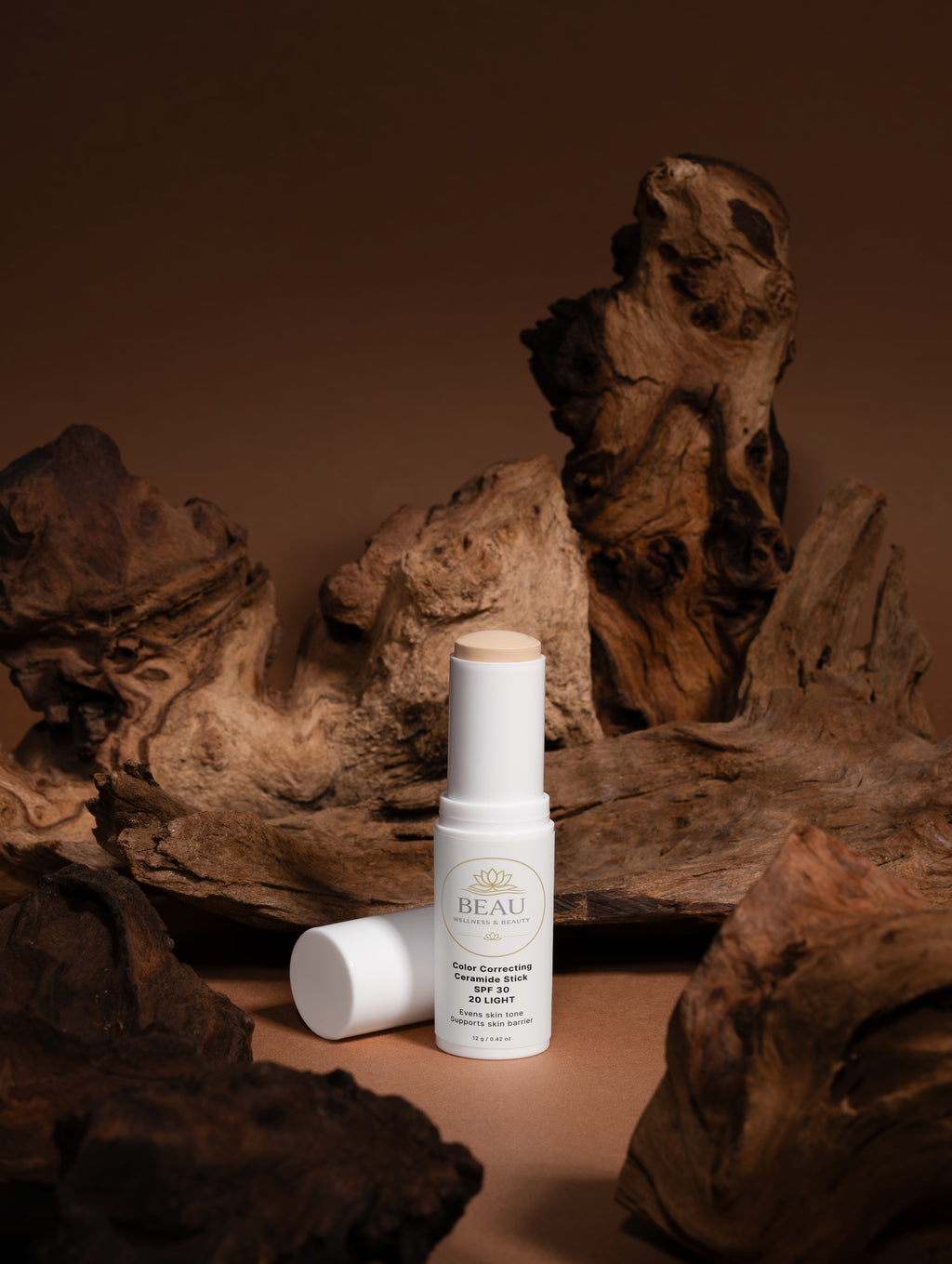 Beau Wellness & beauty CC Ceramide Stick with SPF 30 , shade light 20 on wooded background.