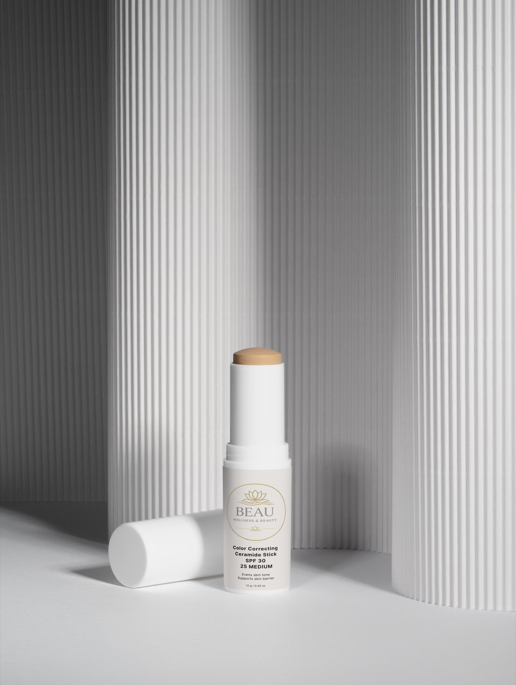 Beau Wellness & beauty CC Ceramide Stick with SPF 30 , shade medium 25  on white lined shadowed background.