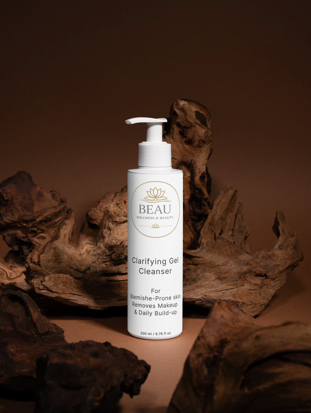 White pump bottle of Beau Wellness & Beauty Clarifying Gel Cleanser on a brown background with natural wood elements