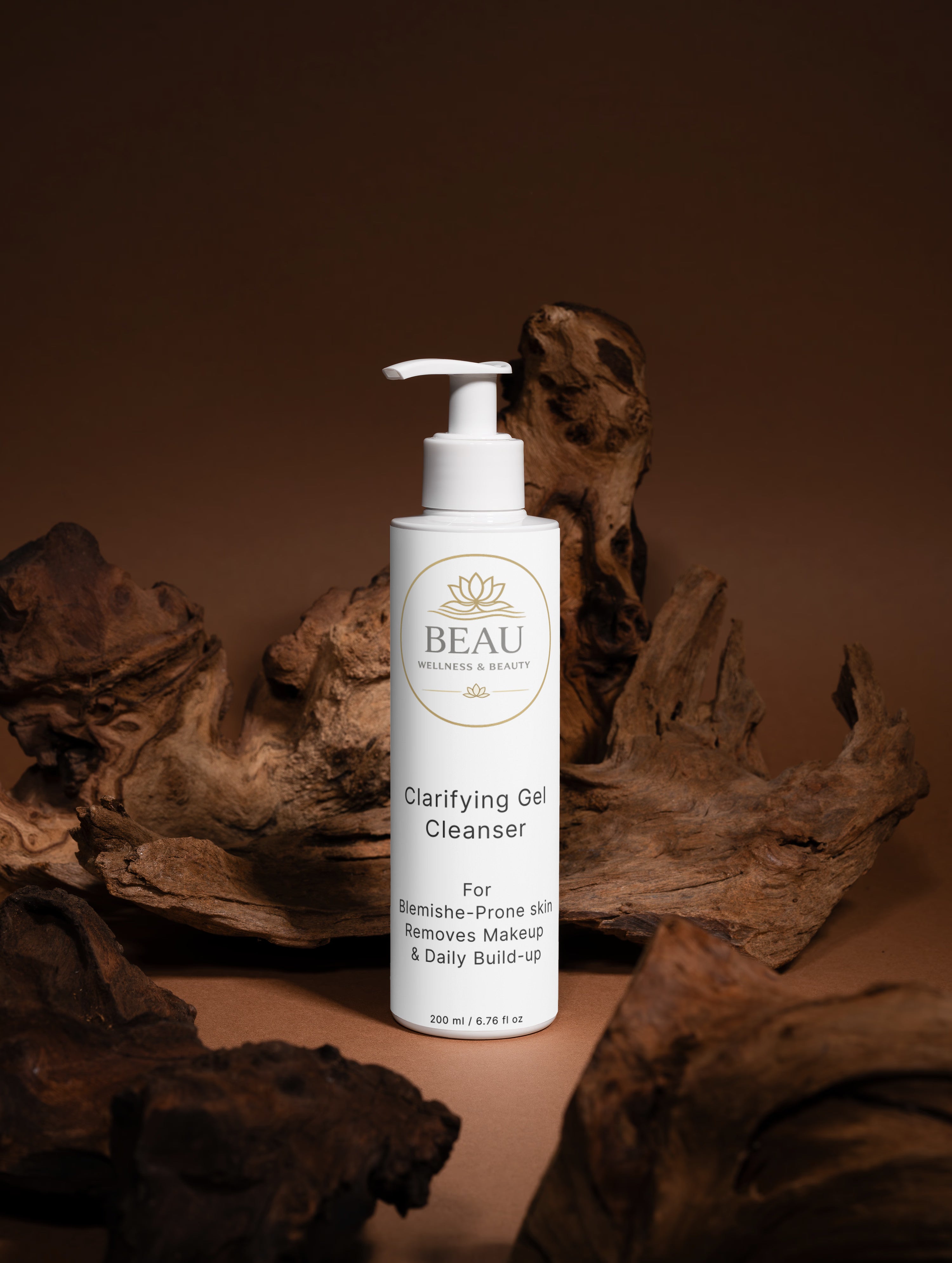 White pump bottle of Beau Wellness & Beauty Clarifying Gel Cleanser on a brown background with natural wood elements