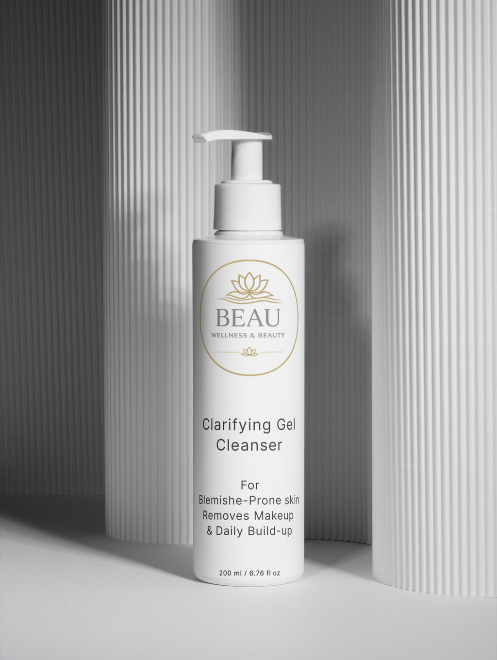 White bottle of Beau Wellness & Beauty Clarifying Gel Cleanser for blemishes and makeup removal with pump on a gray background