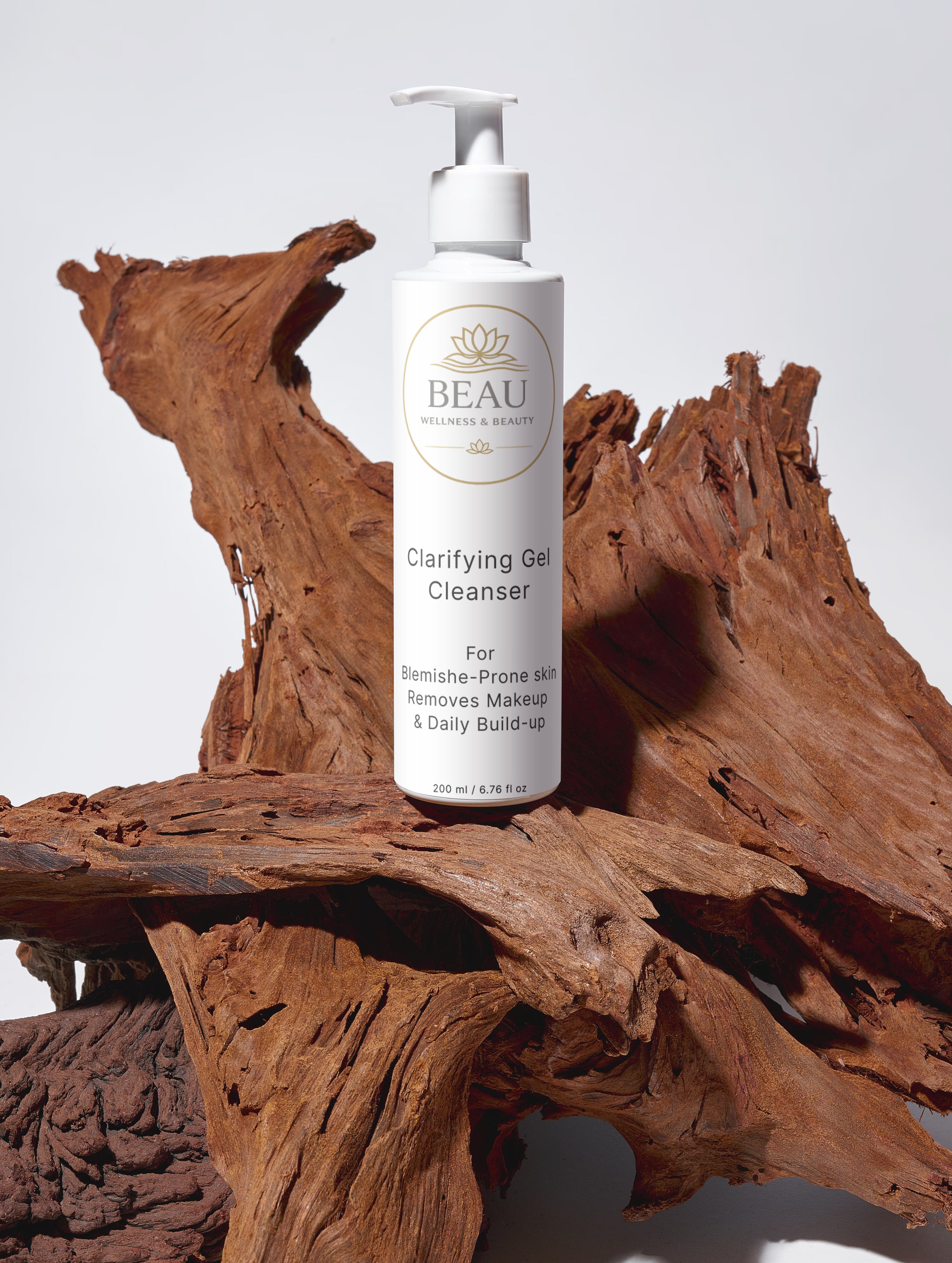 Skincare bottle labeled 'Beau Wellness & Beauty Clarifying Gel Cleanser on a wooden surface