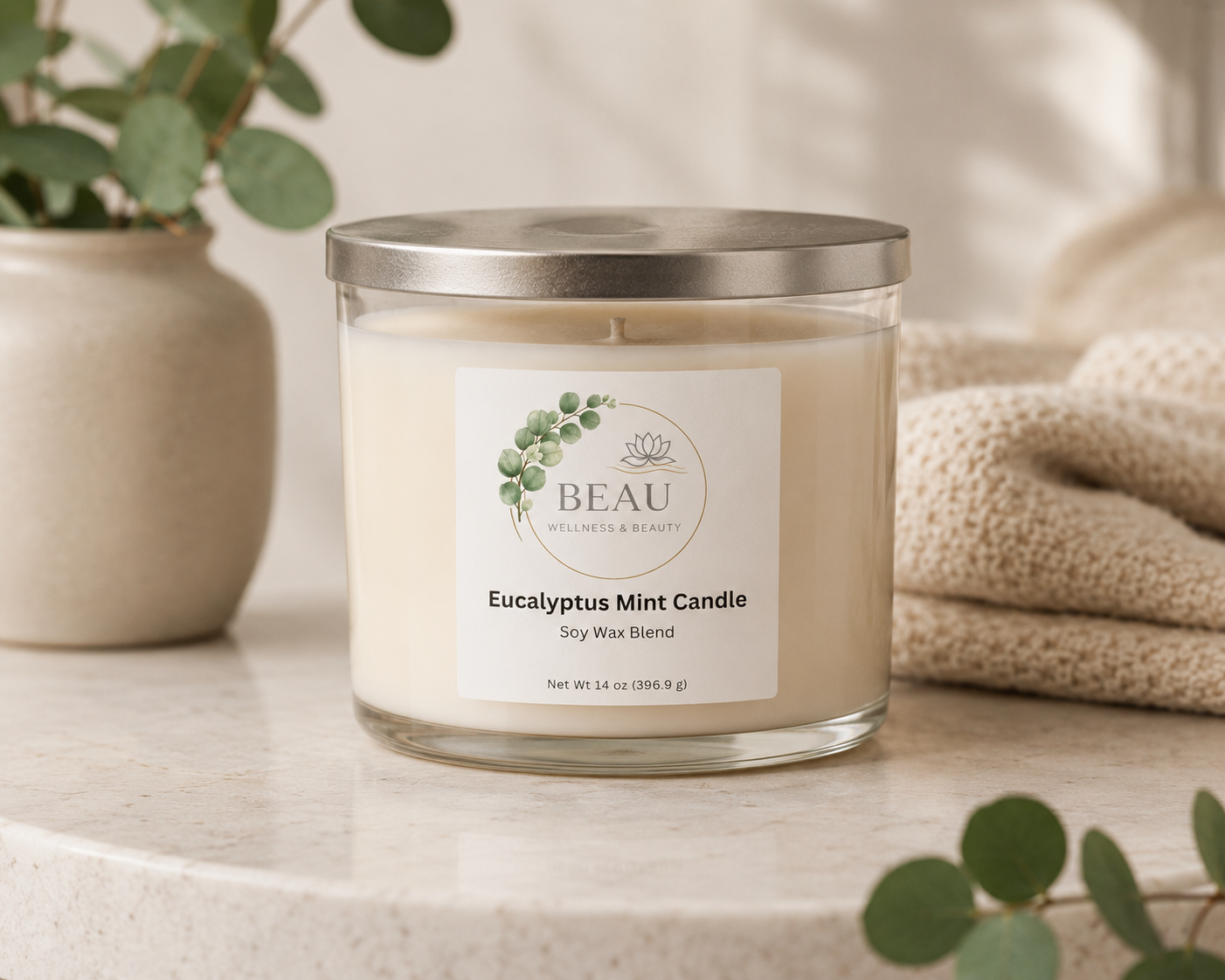 BEAU Wellness & Beauty Eucalyptus Mint Soy Blend candle on a surface with decorative elements