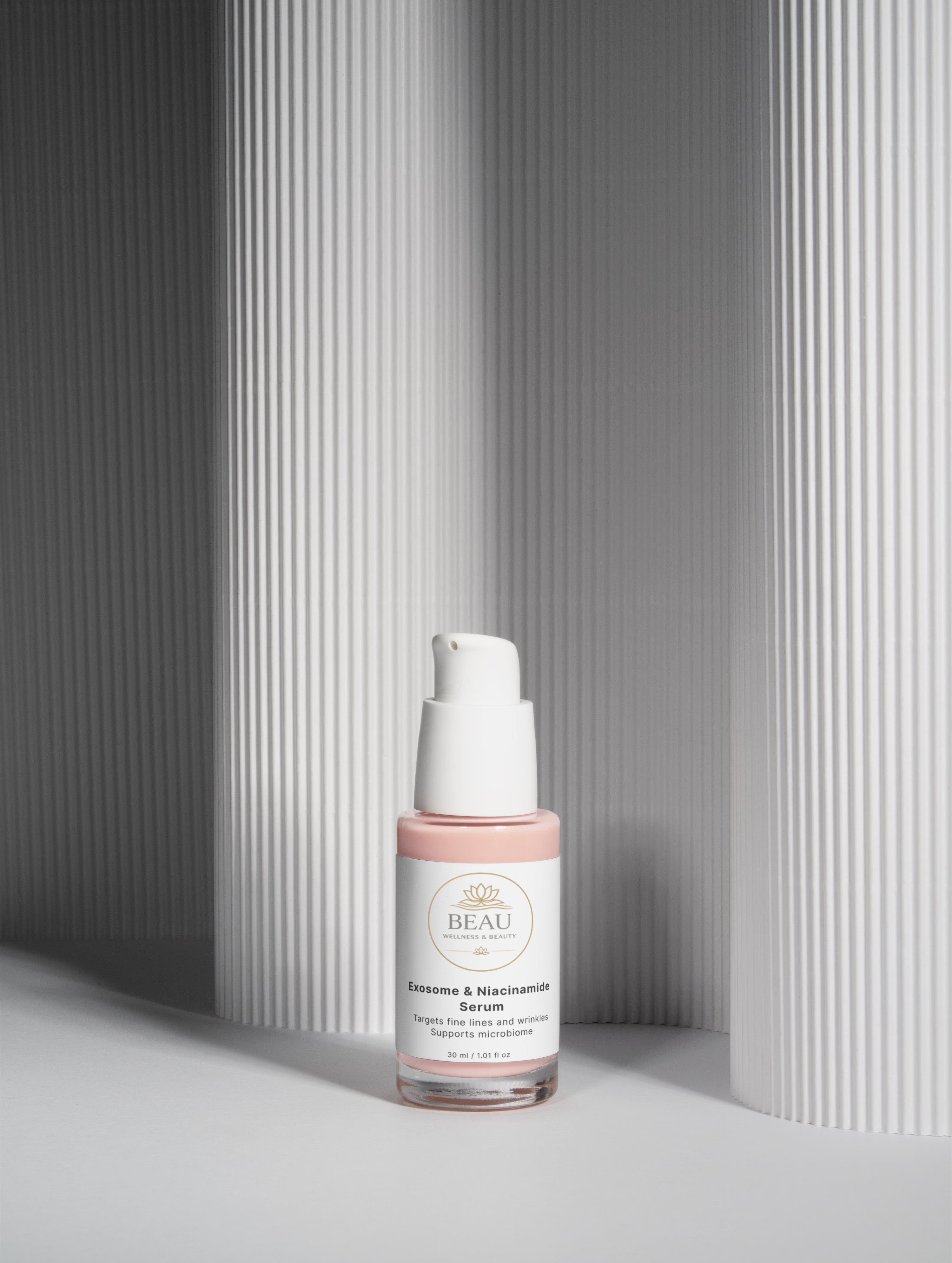 Beau Wellness & Beauty Exosome and Niacinamide Skincare serum bottle placed in a modern, minimalist gray architectural setting with clean geometric lines and shadows.
