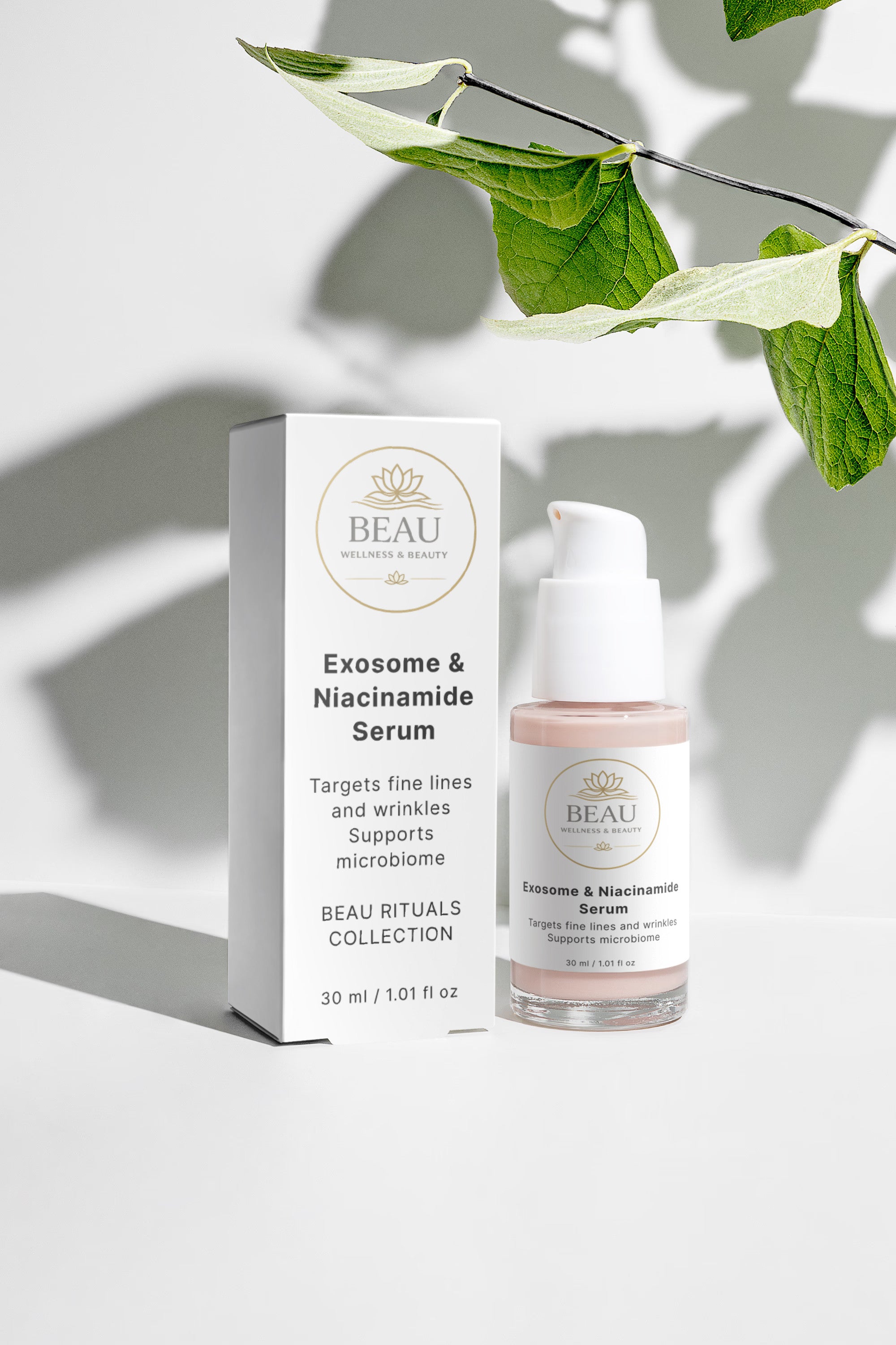 Beau Wellness & Beauty Exosome & Niacinamide Serum pump bottle and white product box styled on a bright white surface with dramatic leaf shadows and green foliage.
