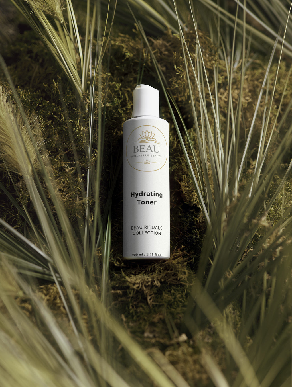 Beau Wellness & Beauty Hydrating Toner with Hyaluronic Acid bottle among grass and plants