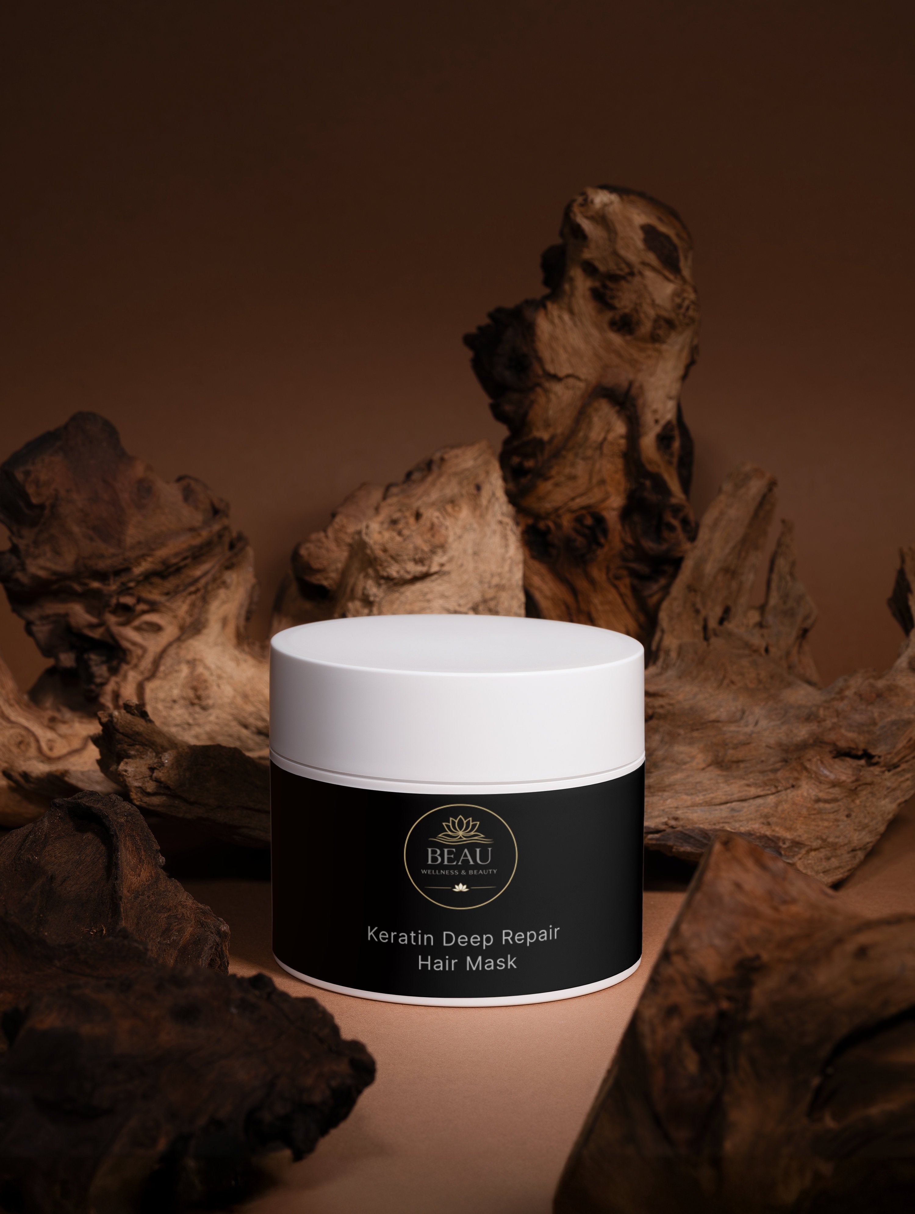 Beau Wellness & Beauty Keratin Deep Repair Hair Mask for dry and damaged hair, featuring hydrolyzed keratin and botanical oils in a wooded background.