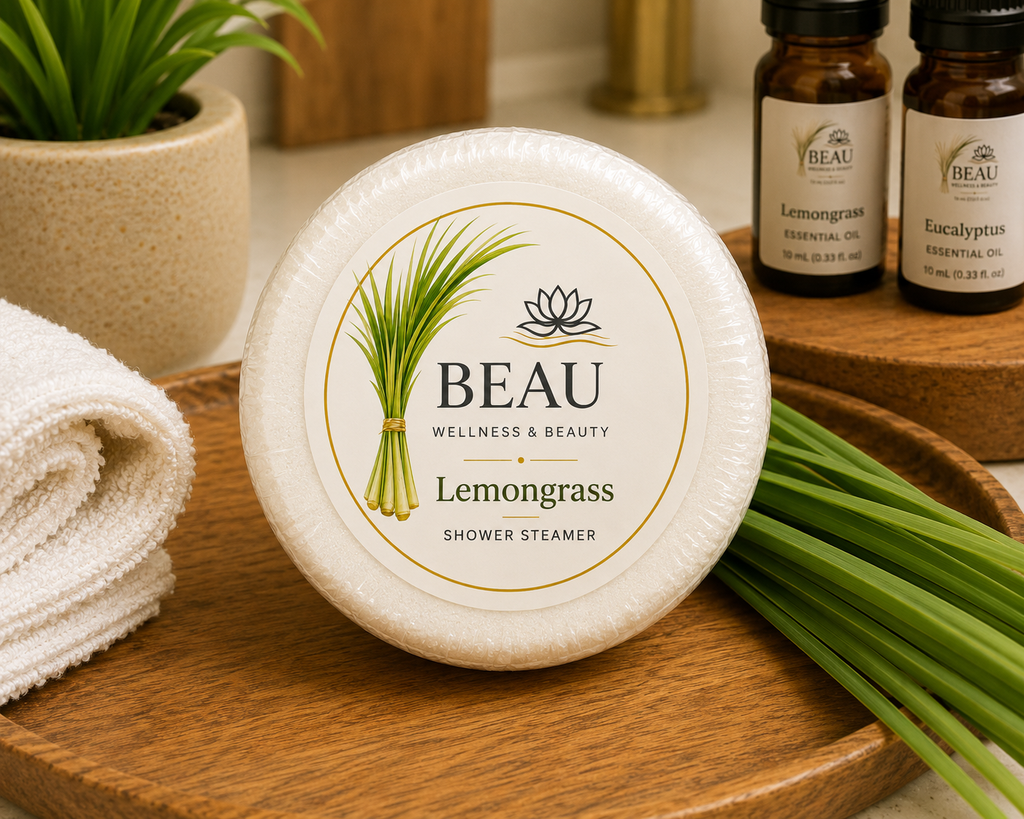 BEAU Wellness & Beauty Lemongrass shower steamer on a wooden tray with towels and essential oils in the background.