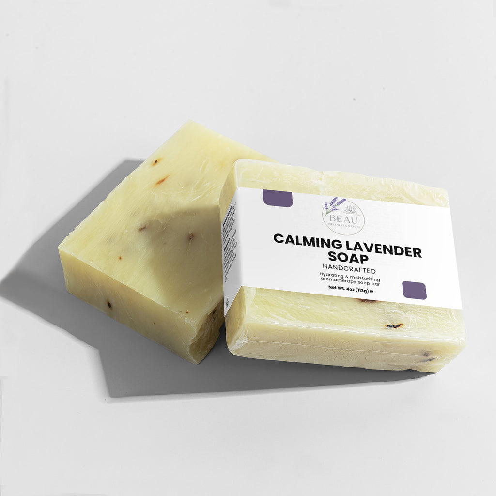 Two bars of Calming Lavender handcrafted Soap with a label on a light gray background