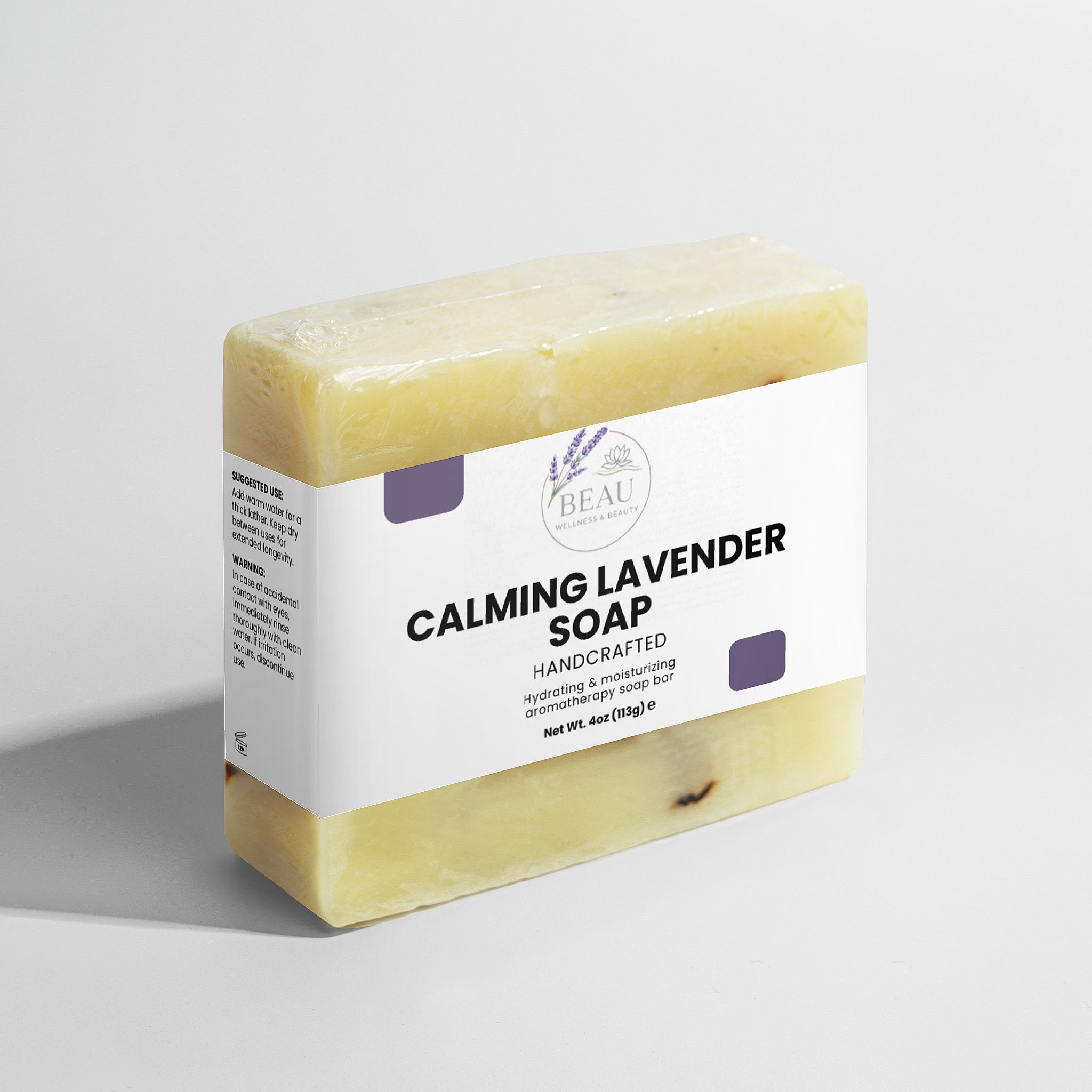 Bar of calming lavender handcrafted soap with a white label on a light gray background