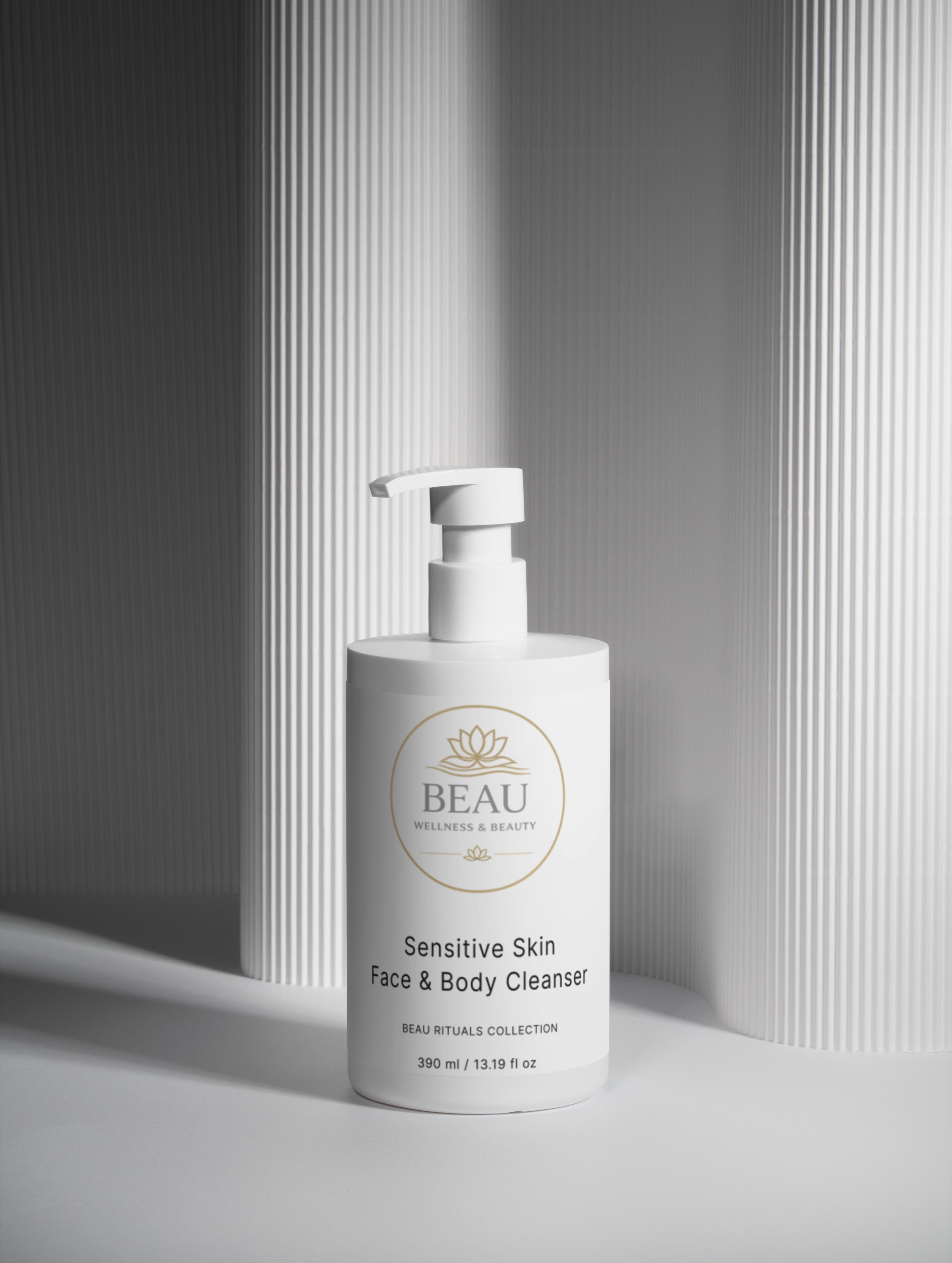 White pump bottle of Sensitive Skin Face & Body Cleanser on a gray background
