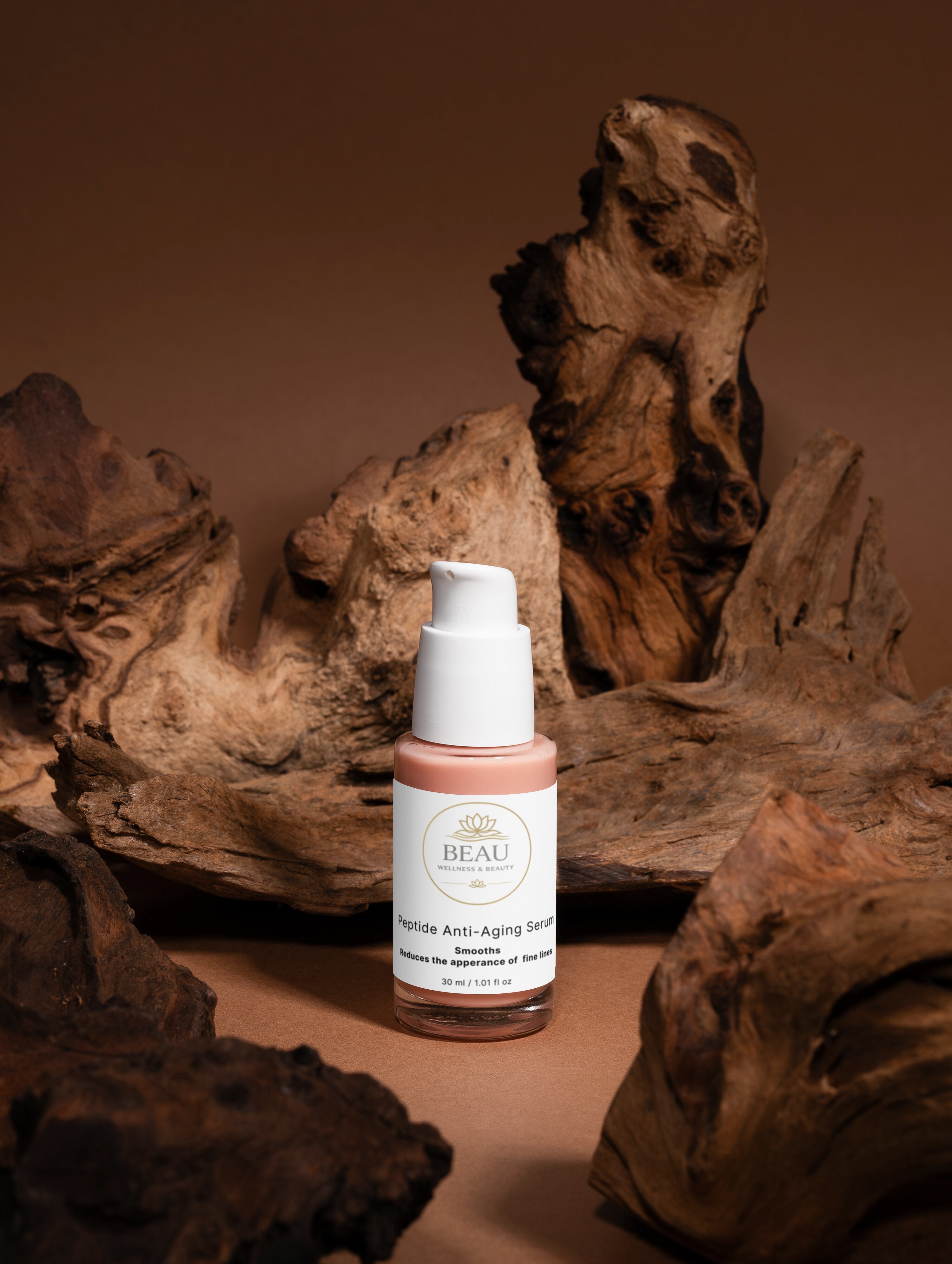 Peptide Anti-Aging Serum bottle with Beau Wellness & Beauty logo on a brown background with natural wood elements.