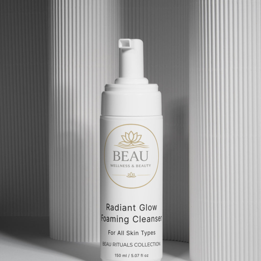 Beau Wellness & Beauty Radiant Glow foaming Cleanser bottle on a neutral column background
