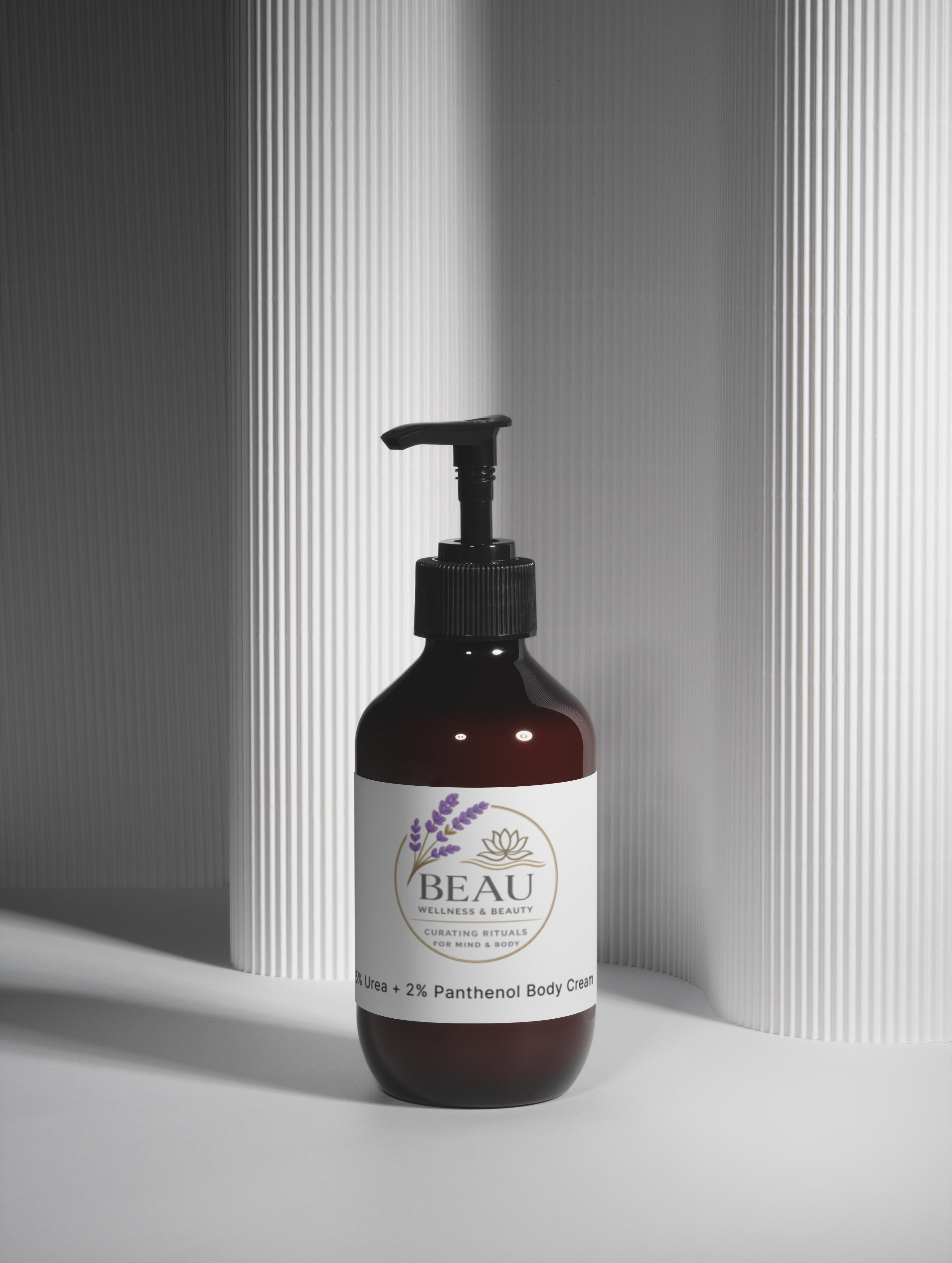 Minimalist amber pump bottle of Beau Wellness & Beauty 5% Urea + 2% Panthenol Body Cream on a clean white background