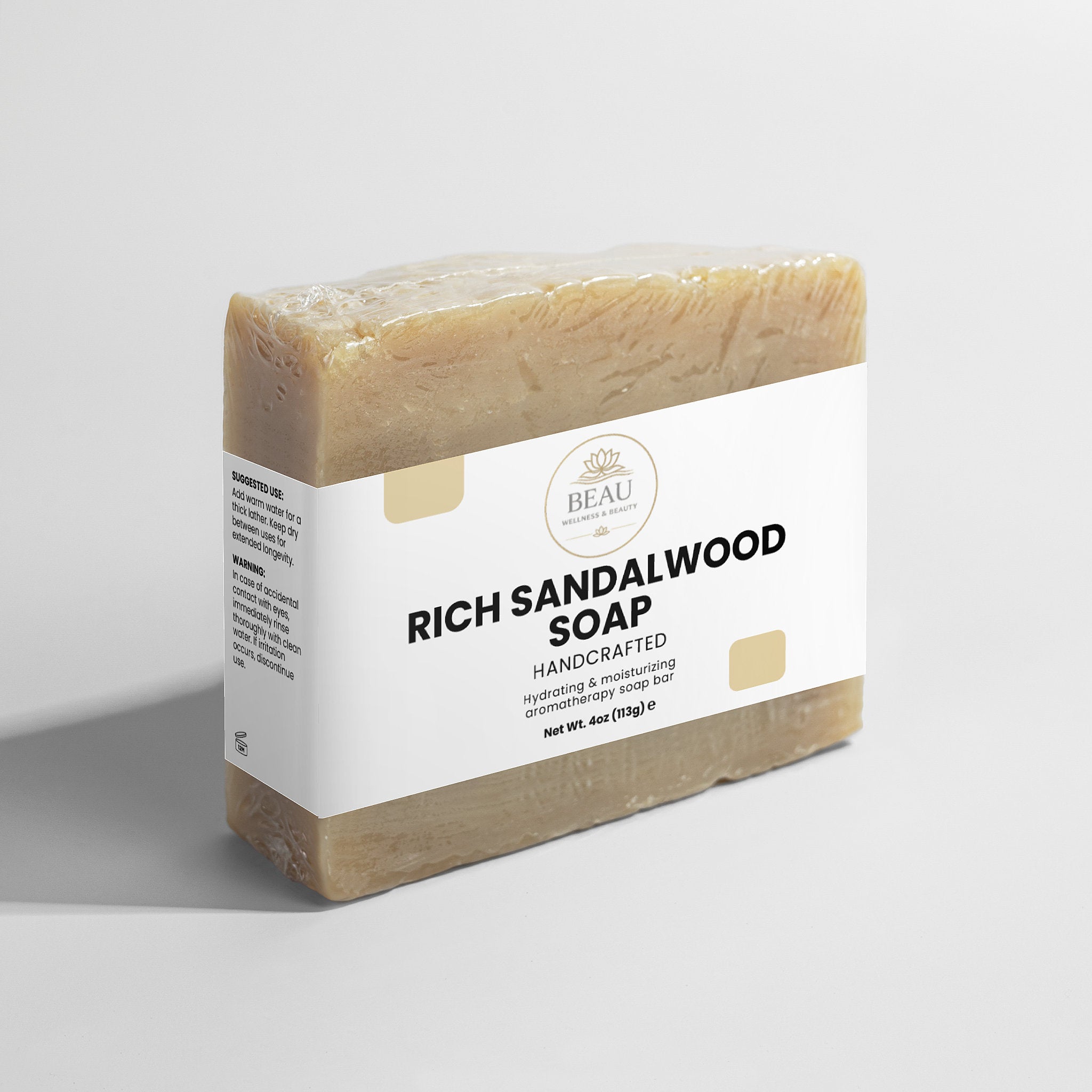 Bar of Rich Sandalwood Soap handcrafted with a white label on a light gray background