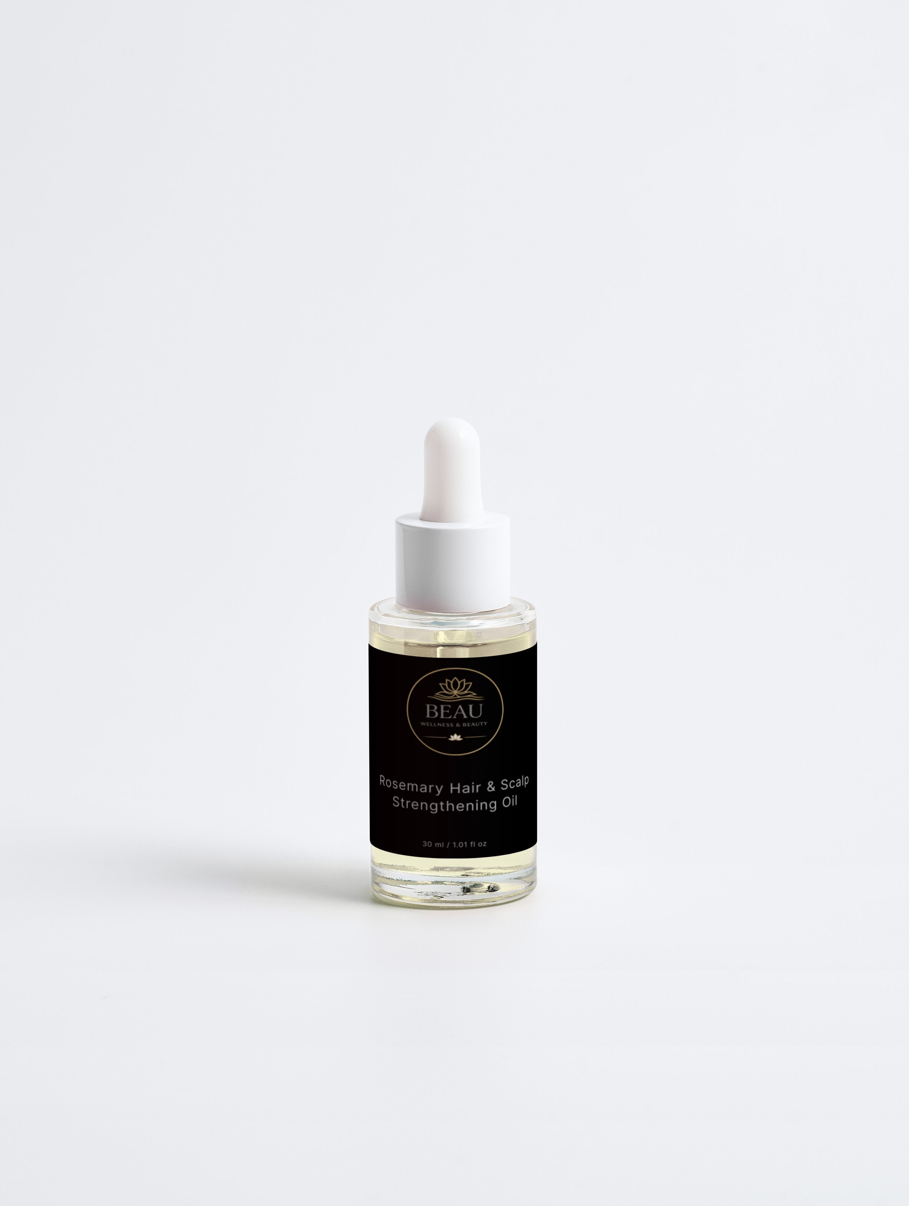 Beau Wellness & Beauty Rosemary Hair and Scalp Strengthening Oil in a clear glass dropper bottle in its luxury black and gold branded label.