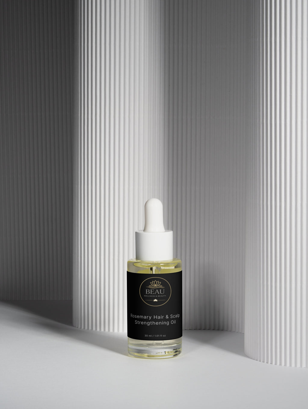 Beau Wellness & Beauty Rosemary Hair and Scalp Strengthening Oil in a clear glass dropper bottle with luxury black and gold branded label.