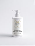 sensitive skin face and body cleanser pump bottle on a light gray background