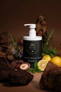 Beau Wellness & Beauty Keratin Volume Boost Shampoo bottle with pump on a brown background with mushrooms, citrus, mint and roemary.